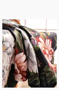 Detail of floral printed tablecloth showing soft, elastic texture and draped fabric folds