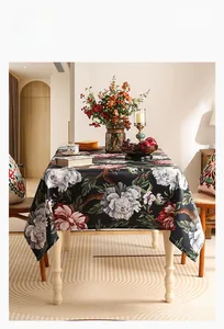 Detail of black floral tablecloth with vintage peony pattern showing elegant fabric drape