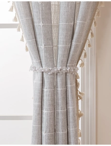 Detail showing elegant faux pearl and acrylic flower beaded curtain tieback on fabric