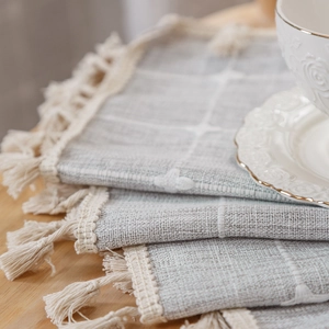 Modern boho linen curtain with grey-blue stripes and elegant tassel trim detail