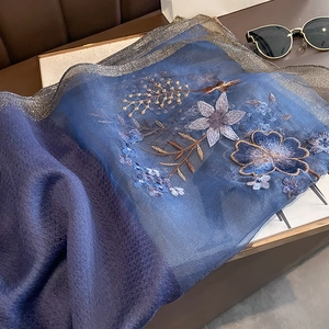 Detailed embroidery on dark blue silk wool scarf with golden floral patterns