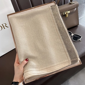 Champagne gold silk shawl featuring shimmering texture and elegant sequin-trimmed borders