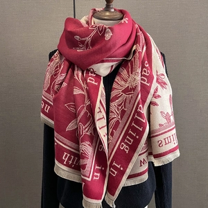 Detail of floral paisley jacquard shawl with thick fringe in burgundy and cream