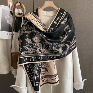 Detail of floral shawl with vintage print and text on soft thick autumn fabric