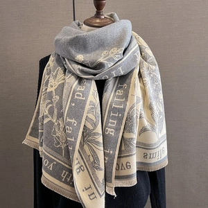 Detail of grey and white scarf with floral pattern and falling in love with you text