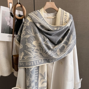 Detail of grey and cream scarf with floral print and falling in love script on wool blend
