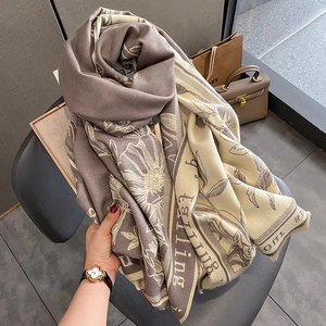 Close-up of thick floral knit scarf with elegant fringe and dual-sided patterns