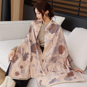 Detail of soft winter shawl featuring vintage floral prints and delicate fringe trim