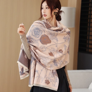 Detail of soft pink cashmere-like shawl featuring vintage floral prints and fringe edges