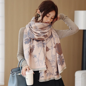 Close-up of elegant floral cashmere shawl scarf with soft fringes and artistic prints