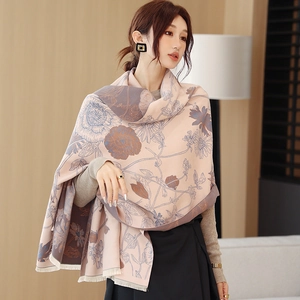 Detail of soft cashmere-feel scarf with elegant floral patterns and fine fringe trim
