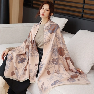Close-up of double-sided cashmere shawl with floral pattern and fringe edge detail