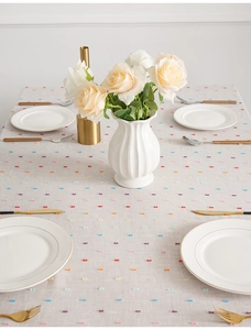 Macro detail of multicolored textured jacquard dots on minimalist linen table runner