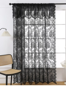 Detail of black lace curtain with floral patterns and elegant ruffled top valance