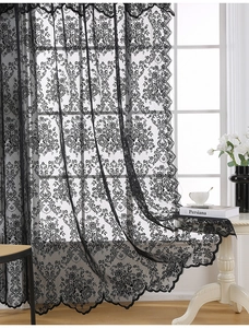 Detailed close-up of vintage black lace curtain featuring delicate floral baroque patterns