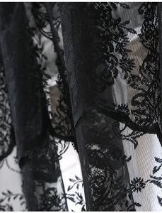 Detailed close-up of French vintage black lace fabric with intricate floral embroidery patterns