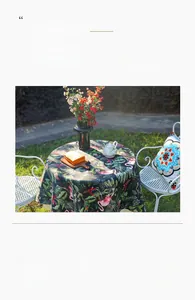 Close-up of tropical floral tablecloth featuring flamingo and monstera leaf patterns