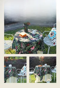 Detailed view of round tablecloth with tropical pink flamingo and palm leaf patterns