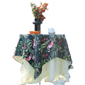 Tropical rainforest tablecloth with flamingo and parrot prints on dark green fabric