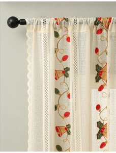 Detail of Christmas bell embroidery on beige lace semi-sheer curtain for festive decor