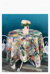 Close-up of circular oil painting style tablecloth with vibrant floral prints and high drape