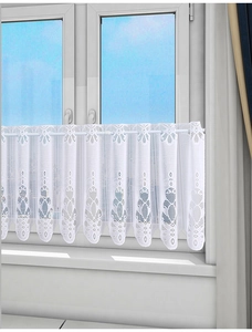 Close-up of white lace kitchen cafe curtain with delicate floral cutout embroidery