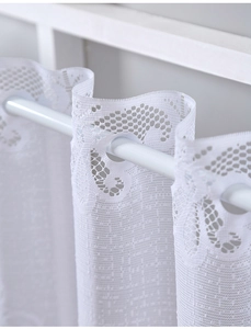 Detail of white lace cafe curtain with floral pattern and rod pocket installation