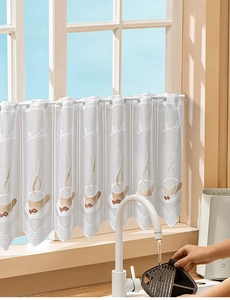 Detail of white lace cafe curtain with embroidered coffee cups and scalloped edges