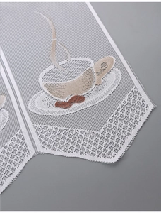 Macro detail of white lace kitchen curtain featuring intricate coffee cup embroidery
