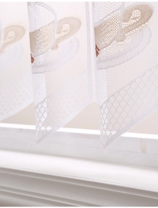 Detail of white lace kitchen curtain featuring embroidered coffee cup patterns and mesh texture