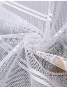 Macro shot of white lace kitchen curtain fabric with warp-knitted mesh and satin stripes