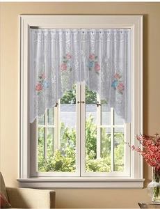 Close-up of white lace kitchen cafe curtain featuring floral patterns and wavy edges