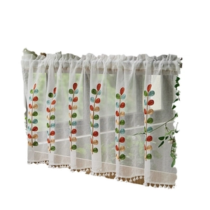 White sheer cafe curtain with colorful leaf embroidery and pom-pom trim for windows