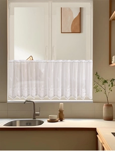 Detailed view of white lace daisy cafe curtain with floral embroidery and scalloped edges