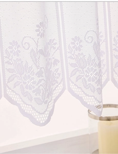 Close-up of white lace curtain featuring delicate floral patterns and wavy scalloped edges