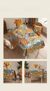 Detail of vintage floral thickened linen tablecloth with orange flowers and green leaves