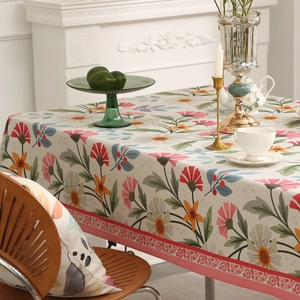 Floral cotton linen tablecloth with red ornate borders for a cozy dining table decor