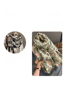 Close-up detail of soft floral cashmere-feel scarf with delicate tassel fringe finish