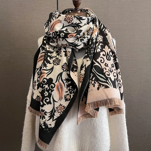 Detailed close-up of retro floral cashmere-feel scarf featuring intricate tassels and patterns