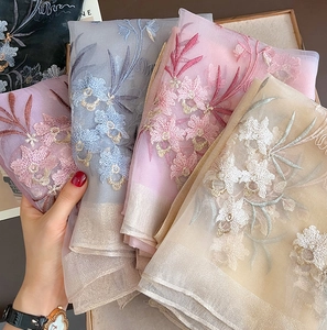 Detailed embroidery on lightweight sheer wool silk scarves with delicate gold wire edges