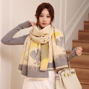 Detail view of winter scarf showing ginkgo leaf pattern and delicate tassel edge texture