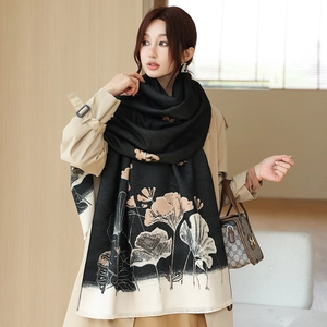 Detail of warm winter scarf with artistic lotus leaf print and delicate fringe edges