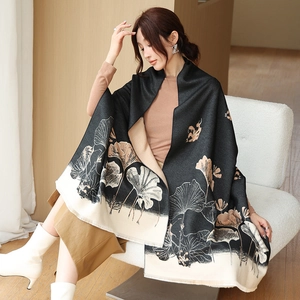 Detail of soft winter shawl with double-sided ginkgo leaf print in black and beige