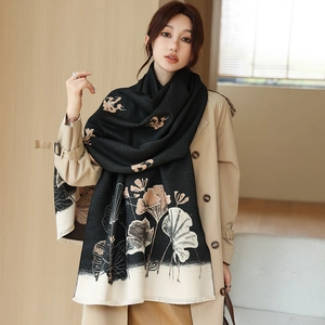Detailed view of black scarf with lotus print, thick material and fringed edges