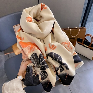 Winter scarf with artistic orange and black gingko leaf pattern and small fringes