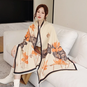 Detailed view of oriental lotus print on soft beige pashmina shawl with tassel edges