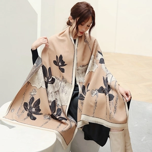 Detailed view of camel cashmere-like scarf featuring lotus prints and soft tassel edges
