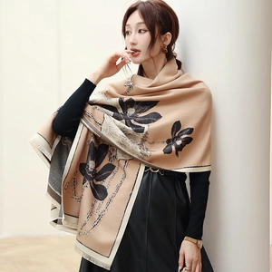 Detailed texture of khaki cashmere pashmina shawl with black lotus print and fringe edges