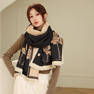 Close-up of thick winter shawl featuring elegant lotus pattern and frayed edge detail