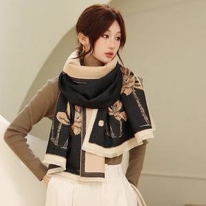 Close-up of dual-tone scarf featuring lotus prints and delicate tassel edge detail